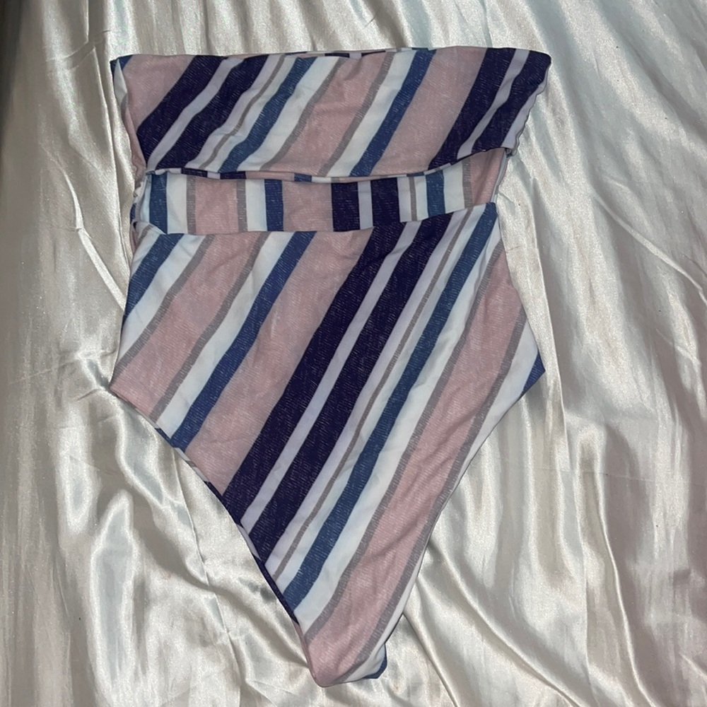 One piece bathing suit never worn! Cheeky with pink, blue, and white stripes.